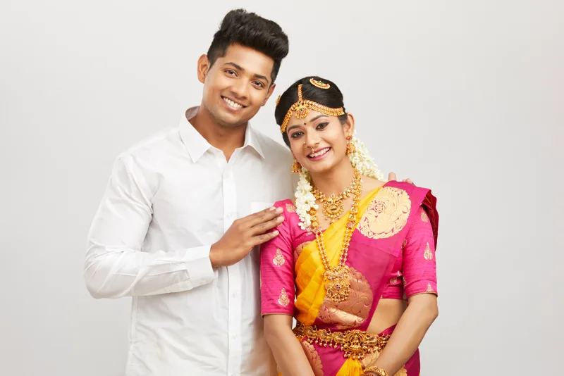 South Indian bride and groom in traditional silk and temple jewellery